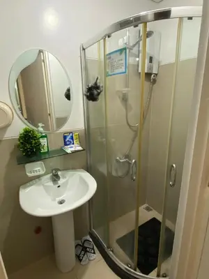 a bathroom with a sink and a shower at Marlouise Place Beacon T1 in Manila