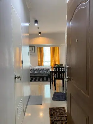 a hallway with a door leading to a bedroom at Marlouise Place Beacon T1 in Manila