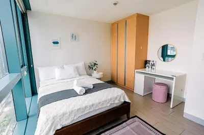 a small bedroom with a bed and a desk at COZI two bedroom family room near Grand Hyatt BGC in Manila