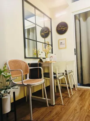 a table and chairs in a room with a window at Condo Staycation - Kanlungan by Anna at Satori Residences, Pasig in Manila