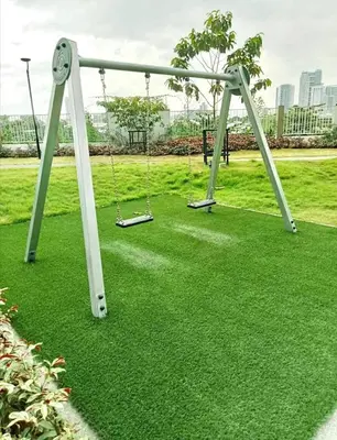 a swing set in a park with green grass at Condo Staycation - Kanlungan by Anna at Satori Residences, Pasig in Manila