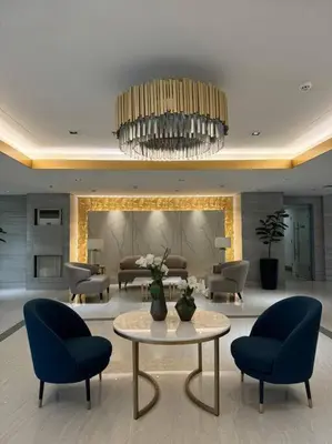 a living room with chairs and a table and a chandelier at Cozy 1BR nr Ortigas Makati & BGC with Secured Parking in Manila
