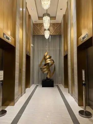 a hallway with a sculpture in a building at Cozy 1BR nr Ortigas Makati & BGC with Secured Parking in Manila