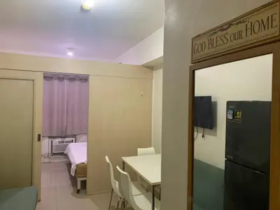 a room with a table and a room with a bedroom at CASSa LISHA in Manila