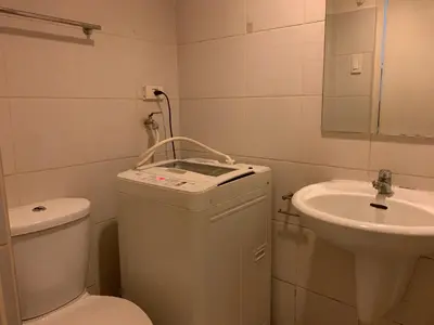 a bathroom with a toilet and a sink at CASSa LISHA in Manila