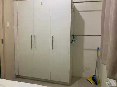 a white closet with white cabinets in a room at CASSa LISHA in Manila