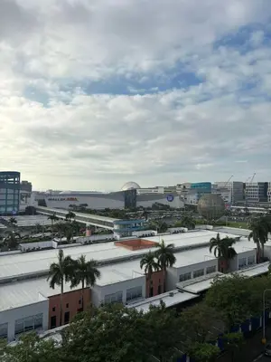 a view of a city with palm trees and buildings at Flores Place At Sea Residences MOA in Manila