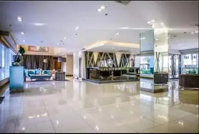 a large lobby with a large room with a lobby at Sea Residences Condo SM Mall of Asia Entertainment District in Manila