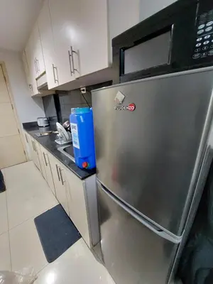 a kitchen with a stainless steel refrigerator at Sea Residences Condo SM Mall of Asia Entertainment District in Manila