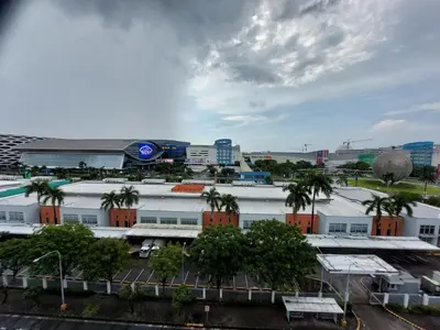 a view of a city with buildings and palm trees at Sea Residences Condo SM Mall of Asia Entertainment District in Manila