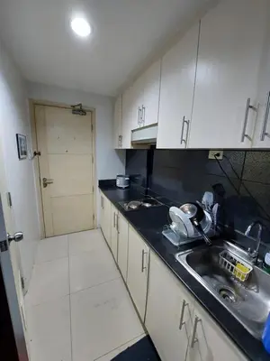 a kitchen with a sink and a counter top at Sea Residences Condo SM Mall of Asia Entertainment District in Manila