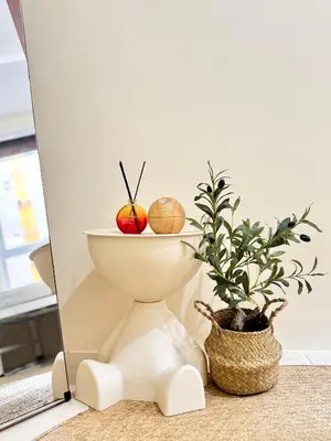 a bowl with an apple on it next to a plant at VR Homes Ortigas - 2BR Condo with Free WiFi & Netflix in Manila