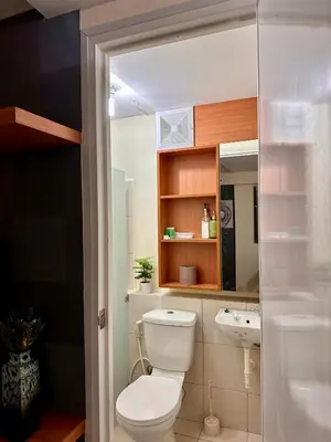 a bathroom with a toilet and a sink at VR Homes Ortigas - 2BR Condo with Free WiFi & Netflix in Manila