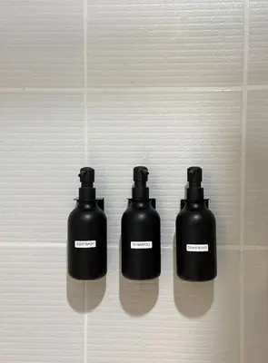 a group of three black bottles on a wall at Suite 101F a New & Spacious MOA Sunrise Drive Oasis in Manila