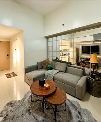 a living room with a couch and a table at Suite 101F a New & Spacious MOA Sunrise Drive Oasis in Manila
