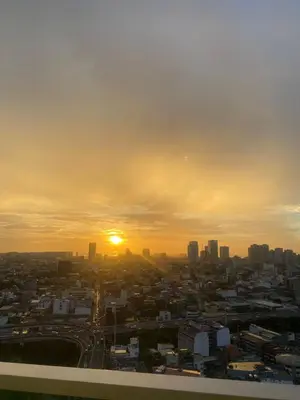 a view of a city with the sunset in the background at 1Bdrm Condo at Makati w Balcony view of Mnla Bay in Manila
