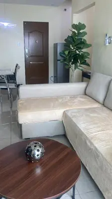 a living room with a couch and a table at 1Bdrm Condo at Makati w Balcony view of Mnla Bay in Manila