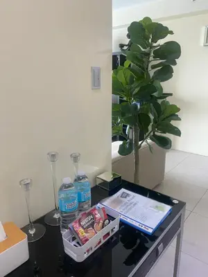 a table with a bottle of water and a plant at 1Bdrm Condo at Makati w Balcony view of Mnla Bay in Manila