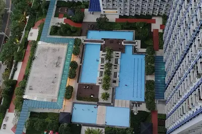 an overhead view of an apartment complex with swimming pools at Aircon Budget Room for 4 persons in Makati in Manila