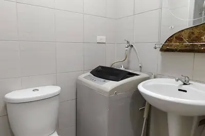 a white bathroom with a toilet and a sink at Aircon Budget Room for 4 persons in Makati in Manila