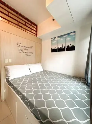 a bedroom with a large bed in a room at Jazz Residences Tower D 1BR in Manila