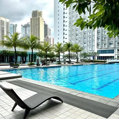 a large swimming pool in a city with buildings at Jazz Residences Tower D 1BR in Manila