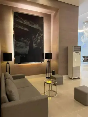 a living room with a couch and a tv at Jazz Residences Tower D 1BR in Manila