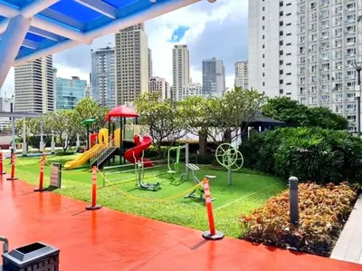 a park with a playground in a city at Jazz Residences Tower D 1BR in Manila