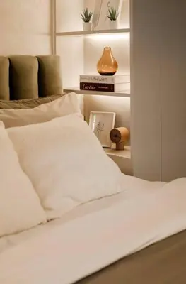 a white bed with white pillows in a bedroom at Lamour Talia in Manila