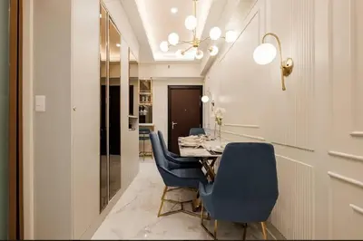 a dining room with a table and blue chairs at Lamour Talia in Manila