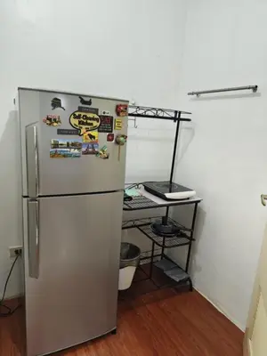 a refrigerator in a room with a desk at Bellagio One Bedrroom BGC Burgos Circle by Christine Suites PH in Manila