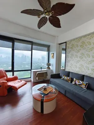 a living room with a couch and a ceiling fan at Bellagio One Bedrroom BGC Burgos Circle by Christine Suites PH in Manila