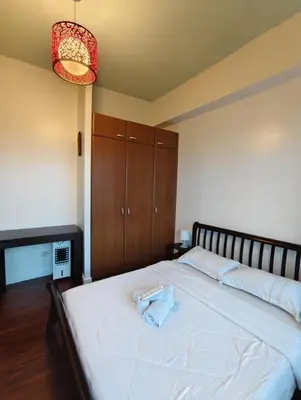 a bedroom with a bed with a towel on it at Bellagio One Bedrroom BGC Burgos Circle by Christine Suites PH in Manila