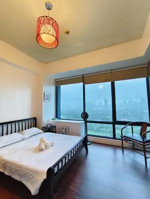 a bedroom with a large bed and large windows at Bellagio One Bedrroom BGC Burgos Circle by Christine Suites PH in Manila