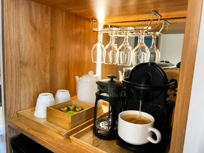 a coffee maker on a shelf in a cupboard at BRAND NEW Casa Airabella with Netflix & Makati City Skyline in Manila