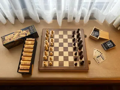 a chessboard and other items on a table at BRAND NEW Casa Airabella with Netflix & Makati City Skyline in Manila