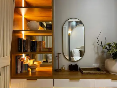 a room with a mirror and a shelf with books at BRAND NEW Casa Airabella with Netflix & Makati City Skyline in Manila