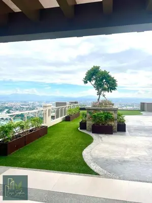 a view from the balcony of a house with a green lawn at CASA SOPHIA Affordable Condo Near Bonifacio Global City BGC CBD in Manila