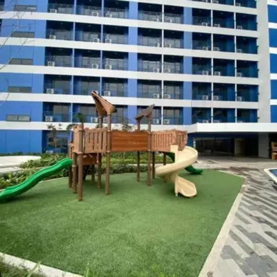 a playground with two play equipment in a building at Air Residence in Manila