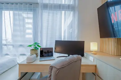 a desk with a computer and a monitor and a chair at Eastwood LeGrand 3 with Ogawa MasterdrivePlus, No Pets Allowed in Manila