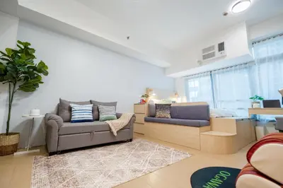 a living room with two chairs and a couch at Eastwood LeGrand 3 with Ogawa MasterdrivePlus, No Pets Allowed in Manila