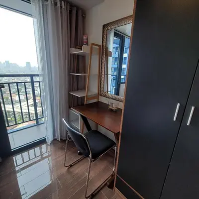 a room with a desk and a mirror and a chair at Air Residences - Panoramic City View near Airport - 2932 in Manila