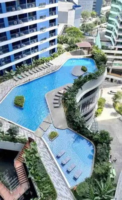 an aerial view of a building with two swimming pools at Air Residences - Pool View near Airport - 1159 in Manila