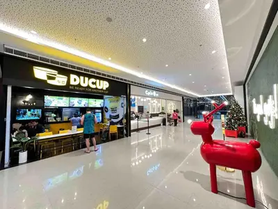 a shopping mall with a red chair in the middle at Air Residences - Balcony City View near Airport - 3521 in Manila