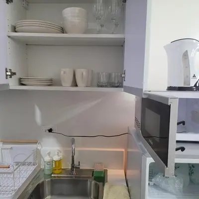 a kitchen with a sink and a microwave at Air Residences - Balcony City View near Airport - 3521 in Manila
