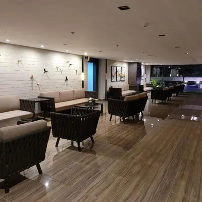 a lobby with couches and tables and chairs at Air Residences - Balcony City View near Airport - 3521 in Manila