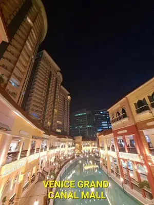 a city street at night with tall buildings at Luxurious Condo Beside Venice Mall #vlrtd20e in Manila