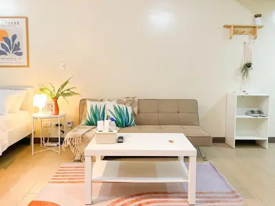 a living room with a couch and a coffee table at Luxurious Condo Beside Venice Mall #vlrtd20e in Manila