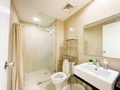 a bathroom with a toilet and a sink and a shower at Luxurious Condo Beside Venice Mall #vlrtd20e in Manila