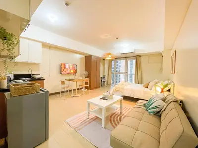 a living room with a couch and a table at Luxurious Condo Beside Venice Mall #vlrtd20e in Manila